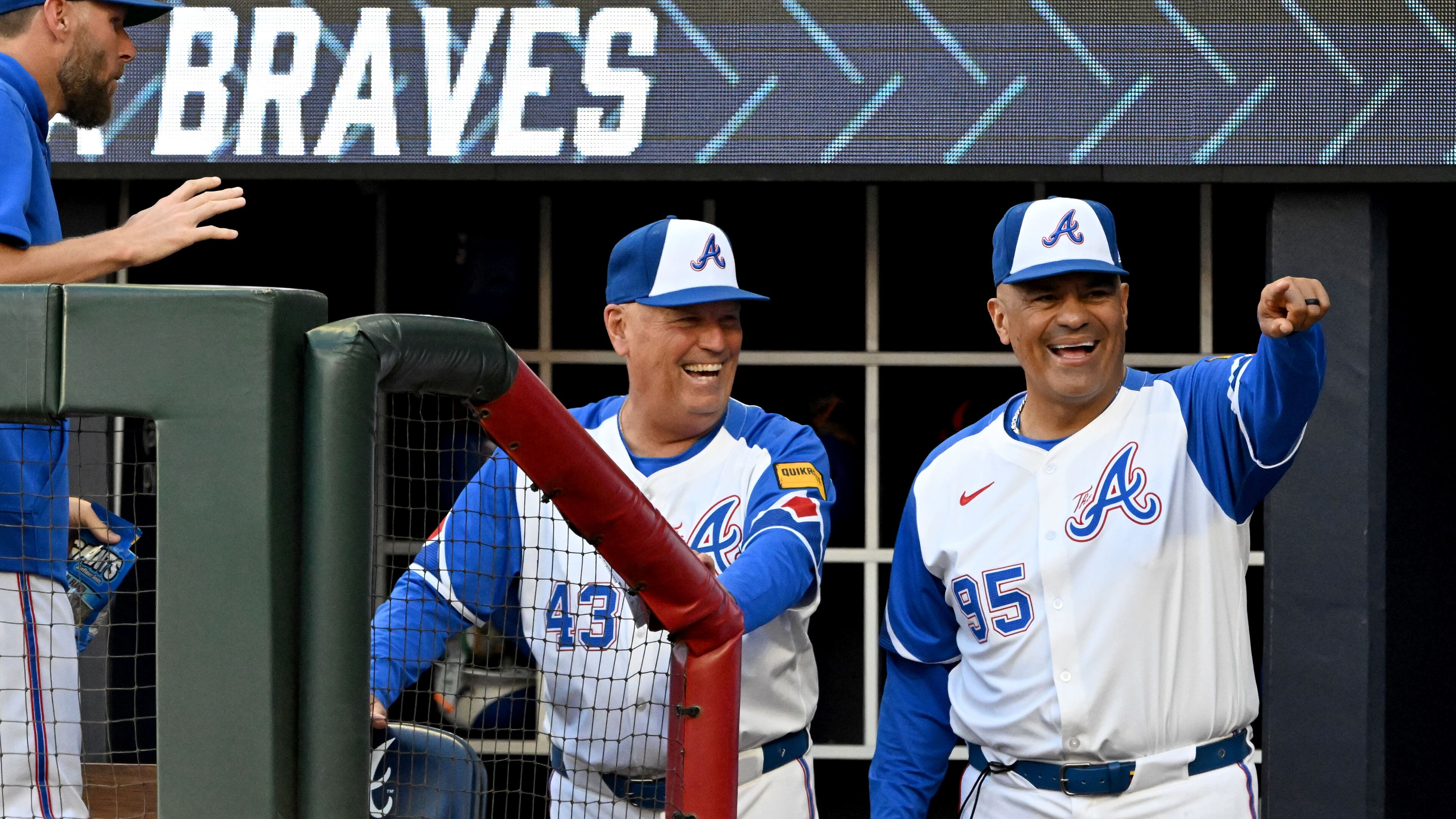 Atlanta Braves coach Eddie Pérez, right, made it a point to learn the proper way to stand during the national anthem, and he takes pride in the process. (Hyosub Shin/AJC)