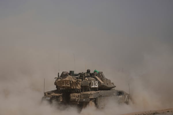 FILE - Israeli soldiers move tanks around a staging area near the border with the Gaza Strip in southern Israel, Sunday, May 18, 2025. (AP Photo/Ariel Schalit, File)