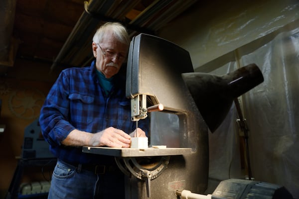 Jones begins to transform a block of wood in his workshop, in the basement of his Decatur home. (Miguel Martinez /miguel.martinezjimenez@ajc.com)