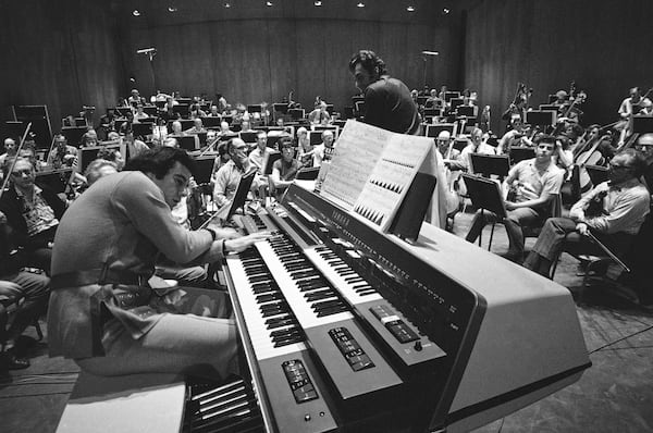FILE - Composer Lalo Schifrin, left, rehearses with the Los Angeles Philharmonic under Zubin Mehta's direction for the world premiere of his "Pulsations" in Los Angeles on Jan. 27, 1971. (AP Photo/George Brich, File)