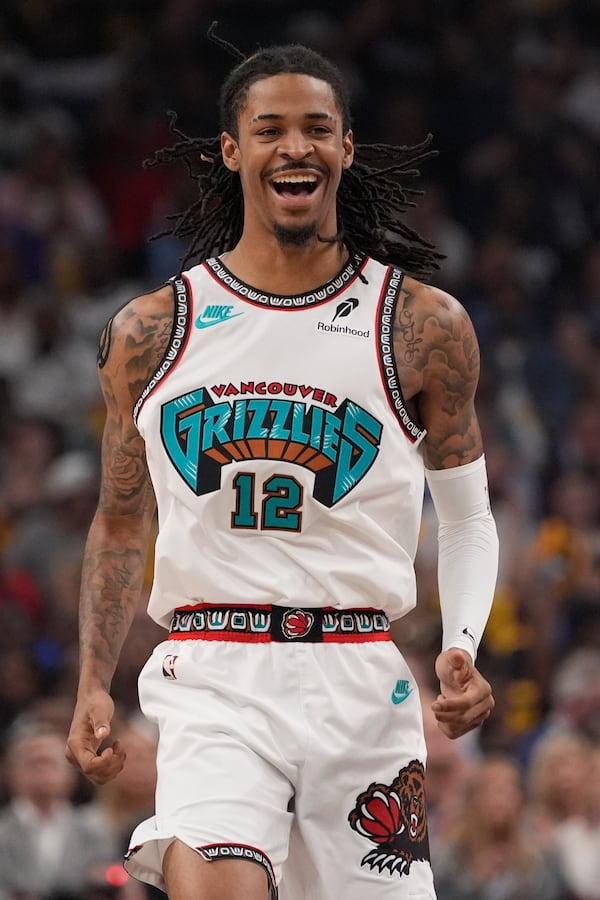 Memphis Grizzlies guard Ja Morant (12) celebrates during the first half of an NBA play-in tournament basketball game against the Dallas Mavericks, Friday, April 18, 2025, in Memphis, Tenn. (AP Photo/George Walker IV)