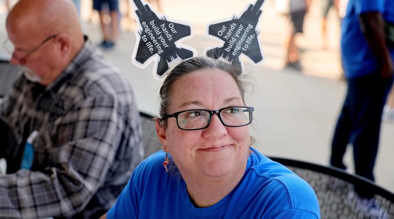 FILE - Christy Williams greets people at the voting check-in table where International Association of Machinists and Aerospace Workers union members picked up their ballot in Maryland Heights, Mo., Sept. 12, 2025, to vote on a negotiated tentative labor agreement that would end their strike against Boeing Defense St. Louis regional operations. (David Carson/St. Louis Post-Dispatch via AP, File)