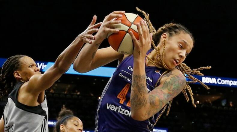 San Antonio Stars' Monique Currie and Phoenix Mercury's Brittney Griner, right, grab for a rebound during first-half WNBA basketball game action Friday, May 19, 2017, in San Antonio. (Edward A. Ornelas/The San Antonio Express-News via AP) AP)