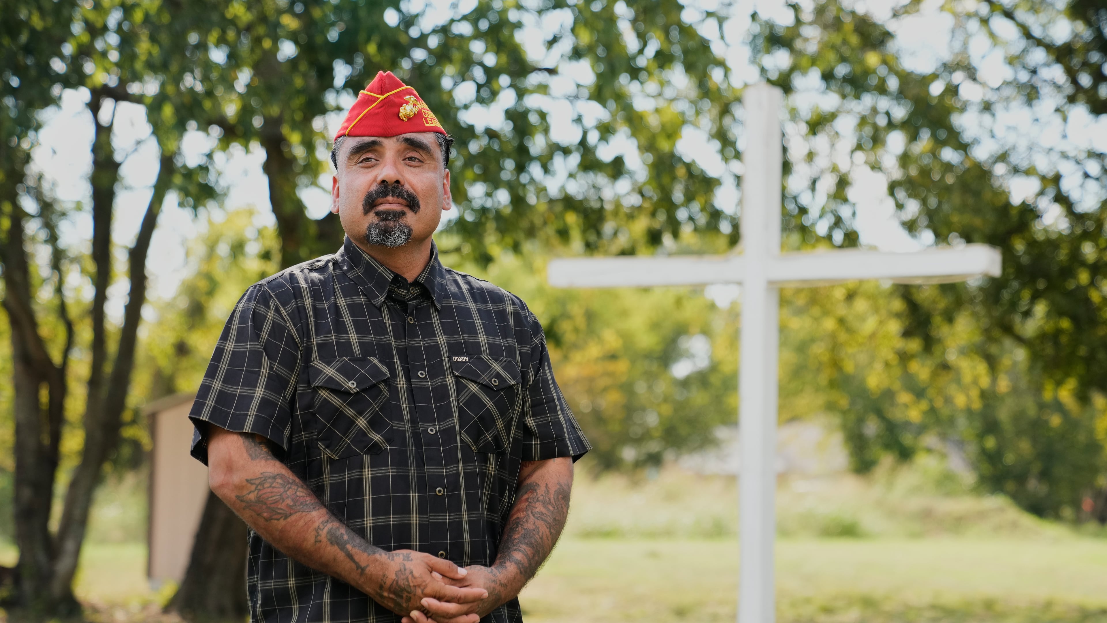 Julio Torres poses for a photo by a cross in an open field, Monday, Sept. 22, 2025, in Terrell, Texas. (AP Photo/Tony Gutierrez)