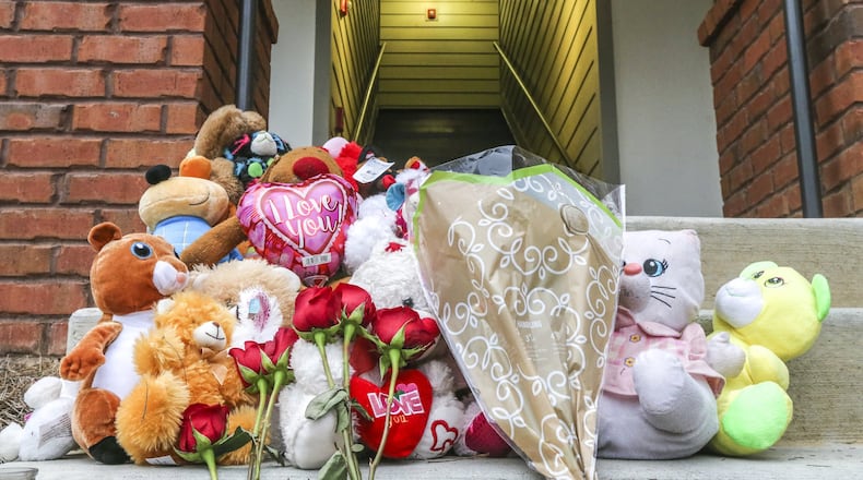 March 26, 2018 Decatur: A memorial was growing Monday, March 26, 2018 on the steps outside the Decatur apartment where the stabbing of deaths of a 14-year-old girl and another person occurred Sunday morning. JOHN SPINK/JSPINK@AJC.COM