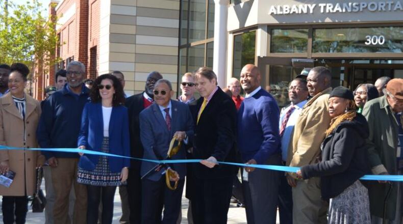 U.S. Rep. Sanford Bishop, holding scissors, and other dignitaries cut the ribbon for the new Albany Transportation Center on Monday. The new facility opens in a week. (Photo Courtesy of Alan Mauldin)