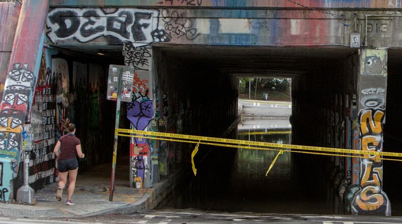 A runner enters the Krog Street tunnel side wallk from Dekalb Avenue on Thursday July 30th, 2020. The tunnel roadway was closed to traffic after it filled with water probably from overnight rainfall. PHIL SKINNER FOR THE ATANTA JOURNAL-CONSTITUTION