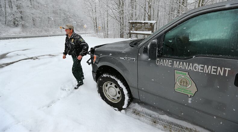 In this 2014 photo, Georgia Department of Natural Resources wildlife technician Scott Bardenwerper works Unicoi Gap on the Appalachian Trail to do public assists aiding hikers who were caught out on the trail in a snowstorm north of Helen. Forest Service officials want to avoid this sort of thing here in 2017 as a winter storm approaches north Georgia.