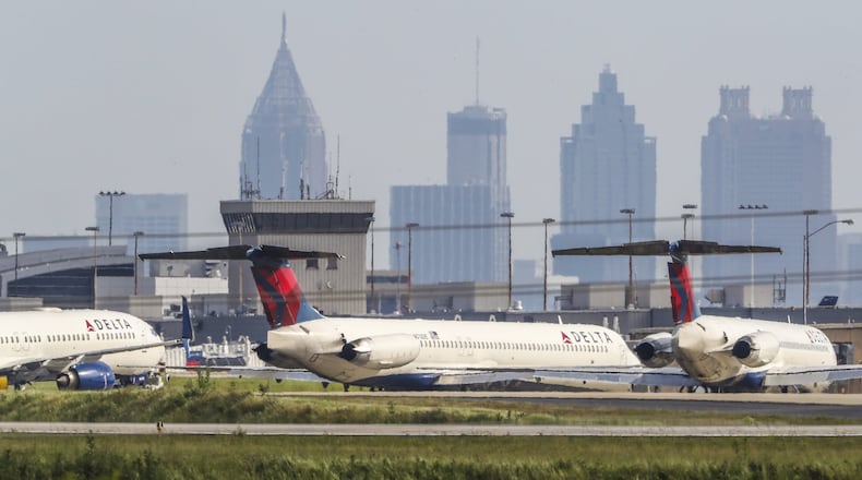 Dozens of commercial jets remained parked along a runway and taxiways at Hartsfield-Jackson on Wednesday, April 29, 2020. JOHN SPINK/JSPINK@AJC.COM