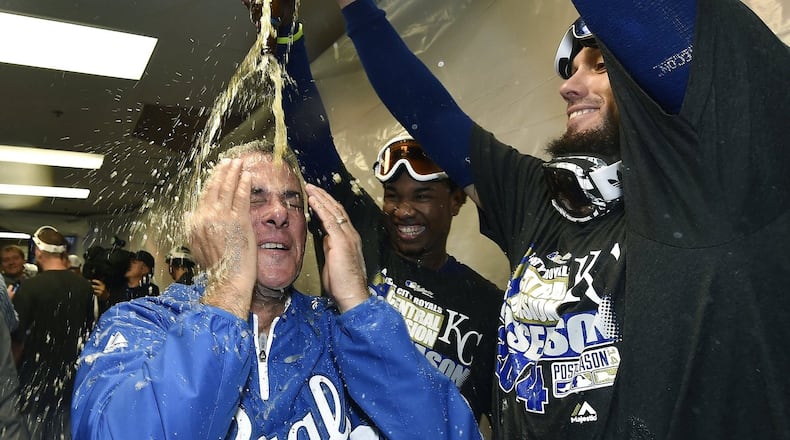 Royals general manager Dayton Moore, who once worked for the Braves, is doused by James Shields and Terrance Gore after the team clinches a wild card. (John Sleezer/Kansas City Star/MCT)