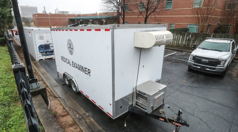 January 8, 2021 Atlanta: Trailers parked outside of the Fulton County Medical Examiner’s office located at 430 Pryor St SW in Atlanta (NOT CONFIRMED if these are used for overflow morgue). Health officials saw the COVID-19 surge coming and sounded alarms, but the holiday get-togethers went on. Now, the scenes officials have dreaded the most since the start of the pandemic are playing out all over Georgia. Hospitals overflow with COVID-19 patients. Some nursing homes are erupting with new cases. Vaccinations are behind, and, for lack of staff, some health districts are limiting COVID testing to get the shots to health care workers and the elderly. Meanwhile, with deaths mounting, the Fulton County Medical Examiner’s office has deployed a refrigerated morgue truck to store bodies. A second truck is ready to go. (John Spink / John.Spink@ajc.com)