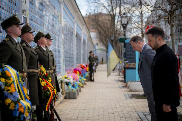 In this photo provided by the Ukrainian Presidential Press Office, Ukrainian President Volodymyr Zelenskyy, right, and Belgium's Prime Minister Bart de Wever, second right, attend a flower laying ceremony at the Memory Wall of Fallen Defenders of Ukraine in Kyiv, Ukraine, Tuesday, April 8, 2025. (Ukrainian Presidential Press Office via AP)