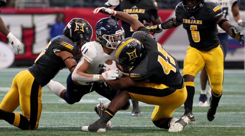 Peach County's Sergio Allen (45) helps bring down Cedar Grove wide receiver Jadon Haselwood (11) during the Class AAA State Championship Tuesday, Dec. 11, 2018, at Mercedes-Benz Stadium in Atlanta.