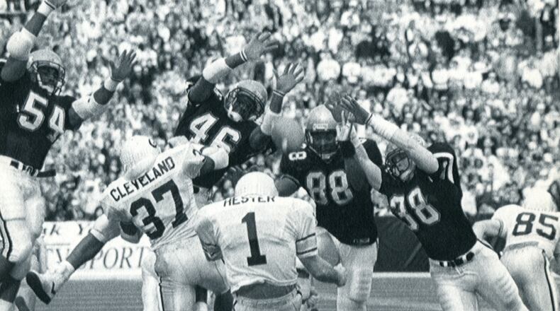 Georgia and Georgia Tech play on Dec. 2, 1989 in Atlanta, GA. Georgia punter Joey Hester gets a block from fullback Brian Cleveland, 37, as Tech rushers seem to fill the air. (AJC FILES/AP STAFF PHOTO BY CHARLES KELLY).