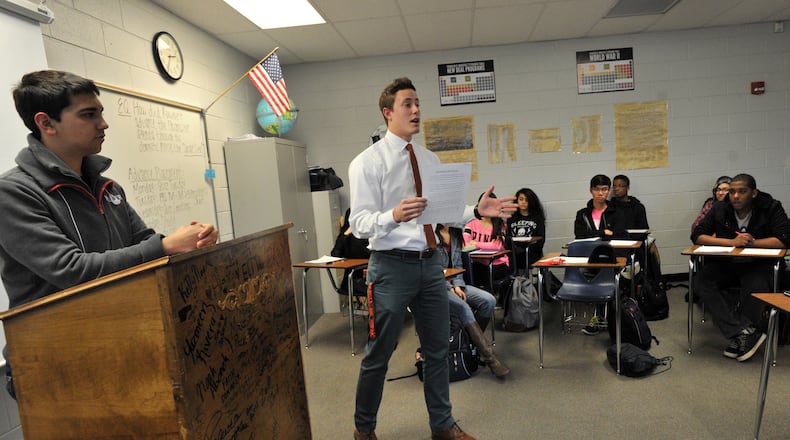 January 15, 2015 Lawrenceville - Andy Dugger (second from left), teaches his AP US History class as Matthew Saadut (left), 17, looks at Central Gwinnett High School in Lawrenceville on Thursday, January 15, 2015. Some Gwinnett County residents say the school district's history courses, particularly Advanced Placement U.S. History, do not properly reflect many moments and people in American history and much of it is anti-American. The critics want Gwinnett, the state's largest school district, to return to the prior AP U.S. history framework and exam. The criticism in Gwinnett is part of a national debate that's emerged in recent months about the course, led by conservatives, after some changes were made to the coursework in 2014. HYOSUB SHIN / HSHIN@AJC.COM In Lawrenceville, Andy Dugger (second from left), teaches his AP US History class as Matthew Saadut (left), 17, looks at Central Gwinnett High School. Hyosub Shin, hshin@ajc.com