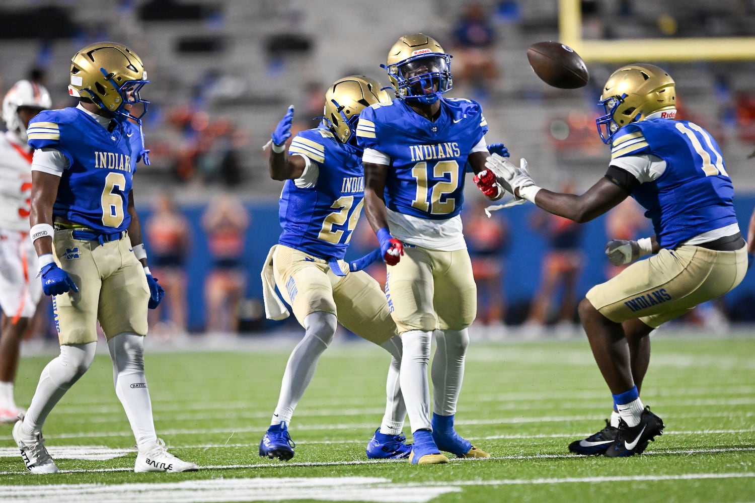 McEachern teammates celebrate quarterback Calvin Pittman Jr (12) interception against North Cobb during the first half of play Friday, August 22, 2025 at McEachern.  (Daniel Varnado/For the Atlanta Journal-Constitution)