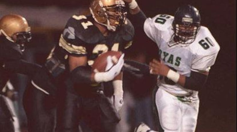Jamal Lewis (31, left) rushed for 1,947 yards and 29 touchdowns to lead Douglass to an 11-2 record and the Region 7-AAAA championship in 1995. Frank Niemeir / AJC File