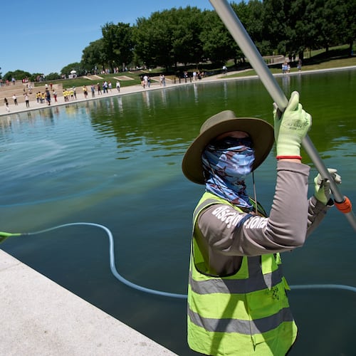 The reflecting pool is cleaned of algae, utilizing "ozone nano bubbles," by National Park Service employees and contractors, Tuesday, June 16, 2026, at the Lincoln Memorial Reflecting Pool in Washington. (AP Photo/Jacquelyn Martin)