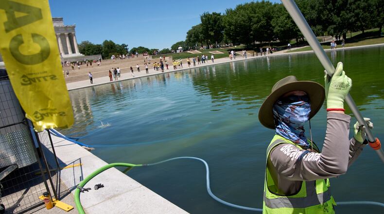 The reflecting pool is cleaned of algae, utilizing "ozone nano bubbles," by National Park Service employees and contractors, Tuesday, June 16, 2026, at the Lincoln Memorial Reflecting Pool in Washington. (AP Photo/Jacquelyn Martin)