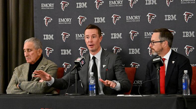 New Atlanta Falcons president of football Matt Ryan (center) speaks as Atlanta Falcons owner Arthur M. Blank (left) and CEO Greg Beadles sit next him during a news conference to introduce new Falcons president of football Matt Ryan, Tuesday, Jan. 13, 2026, in Flowery Branch. (Hyosub Shin/AJC)