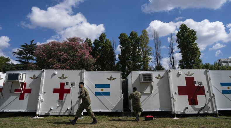 Military personnel do maintenance work on a mobile hospital in Buenos Aires, Argentina, Friday, April 3, 2020. The Air Force there has set up this mobile hospital in case it’s needed to aid people infected with COVID-19. (AP Photo/Victor R. Caivano)