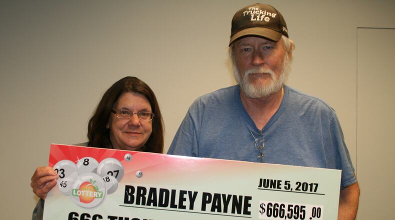 A Fayetteville man, Bradley Payne (right), won $666,595 in the Fantasy 5 Georgia Lottery game. His wife, Patricia Payne, is also pictured. (Credit: Georgia Lottery Corp.)