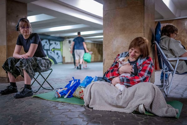 People hide in a metro station, being used as a bomb shelter, during a Russian drones attack in Kyiv, Ukraine, early hours Saturday, July 5, 2025. (AP Photo/Dan Bashakov)