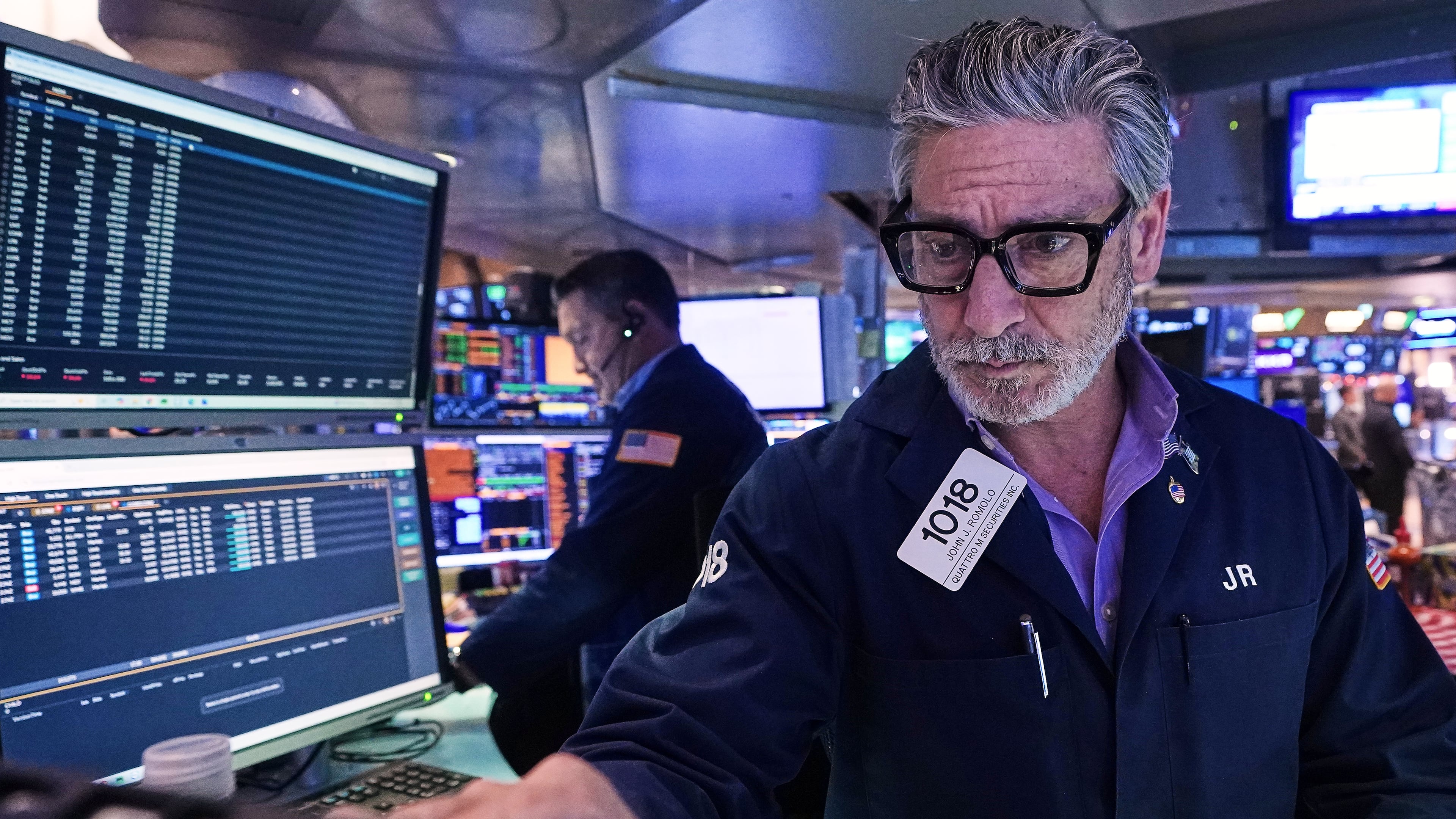 Trader John Romolo works on the floor of the New York Stock Exchange, Tuesday, Dec. 2, 2025. (AP Photo/Richard Drew)