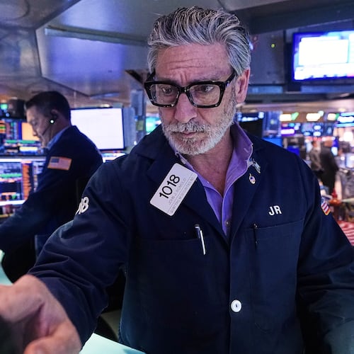 Trader John Romolo works on the floor of the New York Stock Exchange, Tuesday, Dec. 2, 2025. (AP Photo/Richard Drew)