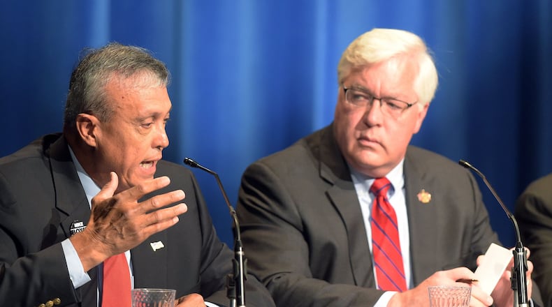 Cobb County Commission chair candidates Mike Boyce (left) and incumbent Tim Lee are shown during an Atlanta Press Club debate. Lee is up for re-election, and Boyce successfully exploited the controversies related to the SunTrust Park deal to garner 49-percent of the vote. The two candidates are headed for a run-off in July. KENT D. JOHNSON/kdjohnson@ajc.com