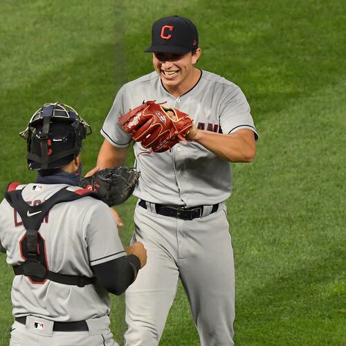 Pitcher James Karinchak (back) — pictured with Cleveland celebrating the final out of a 2020 win with catcher Sandy Leon — has signed a minor league deal with the Braves. (Hannah Foslien/TNS 2020)
