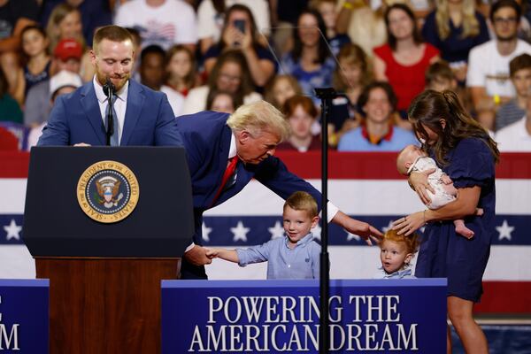 President Donald Trump greets a family who opened Trump Accounts at Wheeler High School in Marietta on July 22, 2026. (Arvin Temkar/AJC)