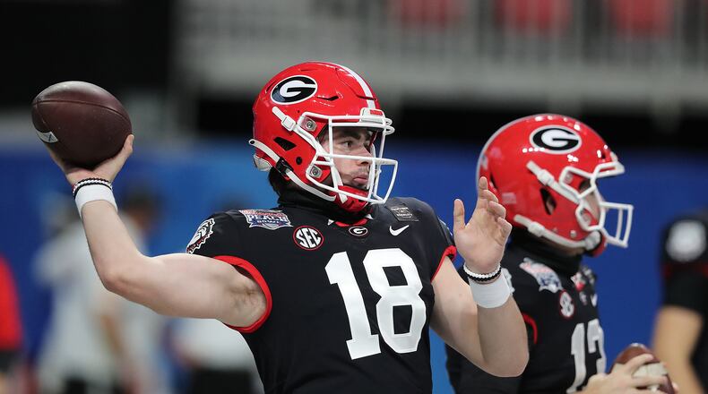 Georgia quarterback JT Daniels (left) and Stetson Bennett (right) prepare to play Cincinnati in the Chick-fil-A Peach Bowl Friday, Jan. 1, 2021, at Mercedes-Benz Stadium in Atlanta. (Curtis Compton / Curtis.Compton@ajc.com)