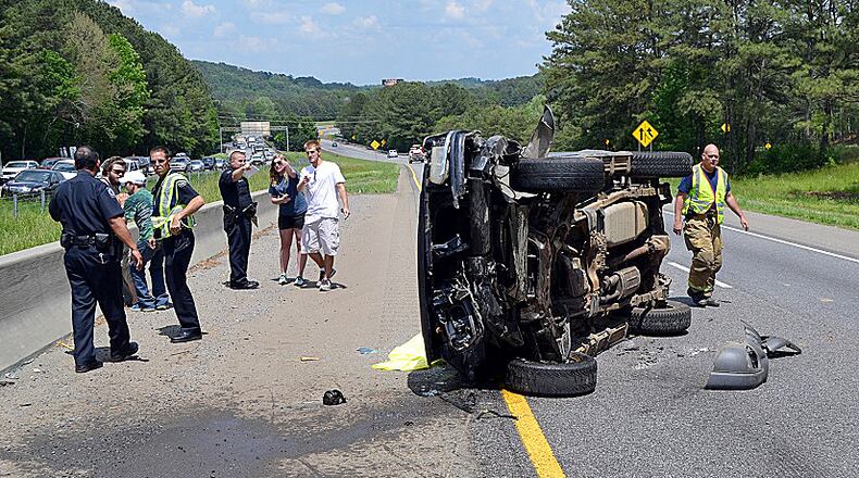 A 3-year-old was not injured when the SUV he was traveling in flipped several times on I-575. (Photo: Tim Cavender/Cherokee County fire department)