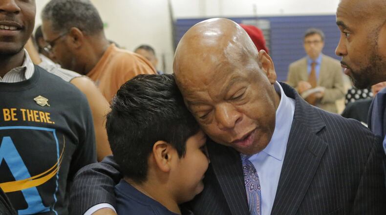 At the end of the program John Lewis spent time with students for hugs and taking photos, including Hugo Hernandez-Cruz. Lewis was on hand, along with Atlanta Public Schools Superintendent Meria Carstarphen for the first day at the new John Lewis Invictus Academy. BOB ANDRES /BANDRES@AJC.COM