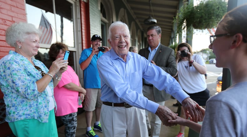 Former President Jimmy Carter received an outpouring of love on social media Saturday, Feb. 18, 2023, after news broke that he was in hospice care. Carter is shown shaking hands as he arrives at a birthday party for his wife, Rosalynn, in 2015 in Plains. (Ben Gray / AJC file photo)