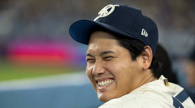 Los Angeles Dodgers' Shohei Ohtani smiles during the ninth inning of a baseball game against the Texas Rangers in Los Angeles, Saturday, April 11, 2026. (AP Photo/Kyusung Gong)