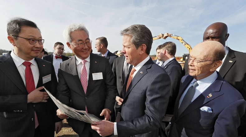 March 19, 2019 - Atlanta - Chey Jae won (from left), SK Executive Vice Chairman, Kim Jun, SK CEO, Gov. Brian Kemp, and U.S. Secretary of Commerce Wilbur Ross look over a full page ad in The Atlanta Journal Constitution promoting the new factory. The South Korean automotive battery maker broke ground in March on a new nearly $1.7 billion battery plant in Jackson County, one of the largest single economic development projects in the state’s history and one that will bring a significant foreign investment — and 2,000 jobs. Bob Andres / bandres@ajc.com