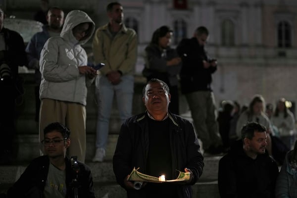 Faithful pray the rosary outside St. Mary Major Basilica, in Rome, Friday, April 25, 2025. (AP Photo/Francisco Seco)