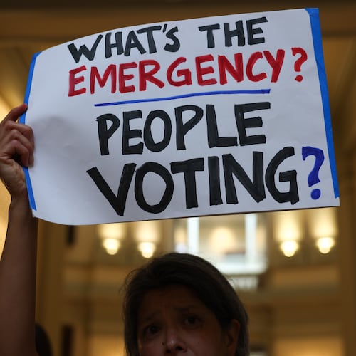 Activists gather at a news conference before the state Legislature convenes for a special session in June. (Arvin Temkar/AJC)