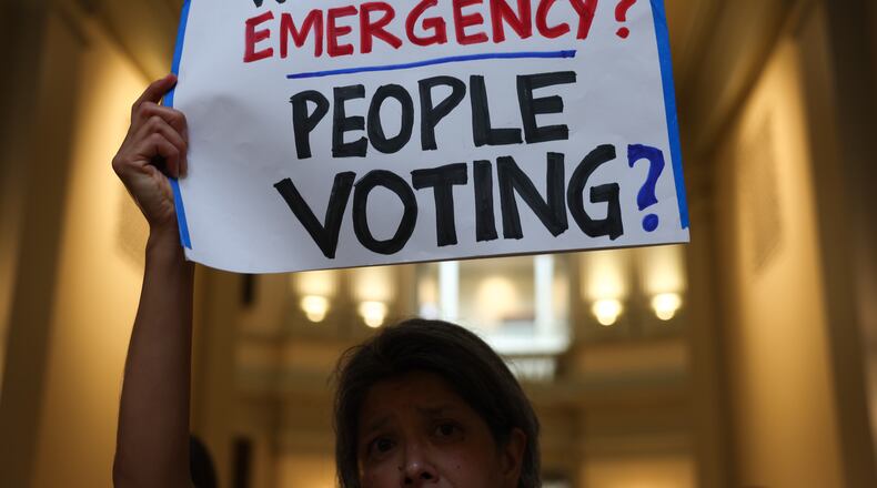 Activists gather at a news conference before the state Legislature convenes for a special session in June. (Arvin Temkar/AJC)