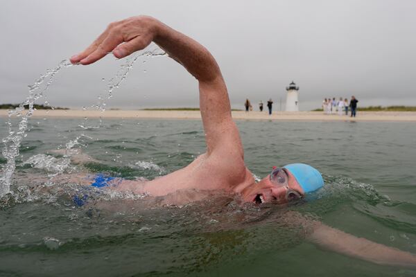 Endurance swimmer Louis Pugh swims near the Edgartown Harbor Light, Thursday, May 15, 2025, in Edgartown, Mass. (AP Photo/Robert F. Bukaty)