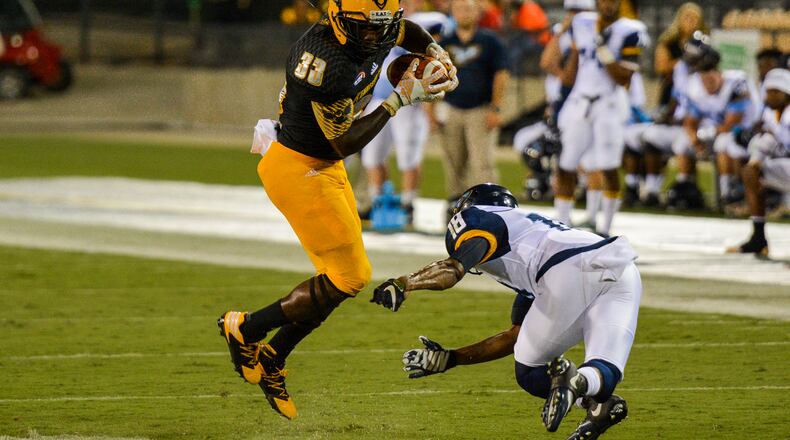 Sophomore running back Darnell Holland jukes Point University defender Javon Horton in the second half, Saturday, Sept. 10, 2016 (AJC/Cory Hancock)