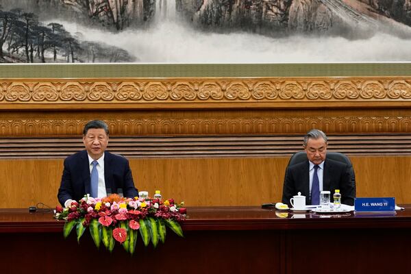 Chinese President Xi Jinping, left, and Foreign Minister Wang Yi attend an event at the Great Hall of the People in Beijing on Friday, March 28, 2025. (AP Photo/Ng Han Guan)