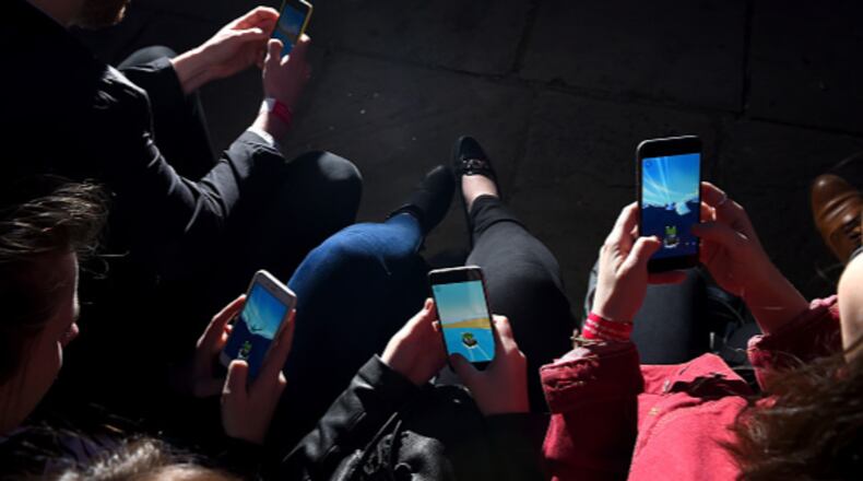 Young people are pictured on their smartphone devices, ignoring those around them. A Colorado group is trying to get an initiative on next year’s ballot that would criminalize selling a smartphone to anyone under 13.