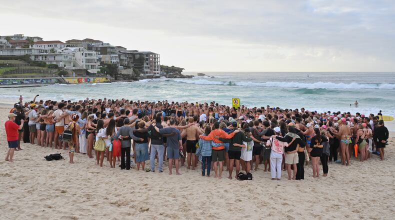 Swimmers gather for a morning vigil in Sydney, Wednesday, Dec. 17, 2025, following Sunday's shooting at Bondi Beach. (Mick Tsikas/AAP Image via AP)/AAP Image via AP)