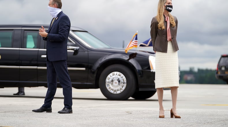 FILE -- Rep. Doug Collins (R-Ga.) and Sen. Kelly Loeffler (R-Ga.) wait to greet President Donald Trump at the airport in Atlanta on Sept. 25, 2020. Collins is running in a special election against Loeffler, who was appointed to her seat; but the Democrat in that race, Raphael Warnock, is now leading in a poll. (Anna Moneymaker/The New York Times)