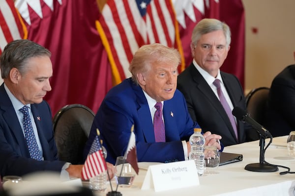 President Donald Trump speaks, seated between Kelly Ortberg President and CEO of Boeing, left, and Larry Culp, CEo of GE Aerospace during a business roundtable, Thursday, May 15, 2025, in Doha, Qatar. (AP Photo/Alex Brandon)