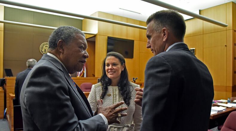 Robb Pitts (left), chairman of Fulton County Board of Commissioners, celebrates with Meria Carstarphen, superintendent of Atlanta Public Schools, and Jeff Rose (right), superintendent of Fulton County Schools, after a judge ruled on Aug. 14 that Fulton County could collect tax money. HYOSUB SHIN / HSHIN@AJC.COM