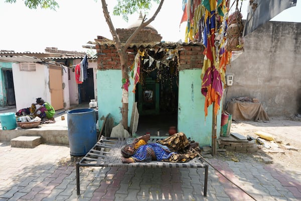 An elderly woman rest in the shade of a tree in Ahmedabad, India, Wednesday, April 2, 2025. (AP Photo/Ajit Solanki)